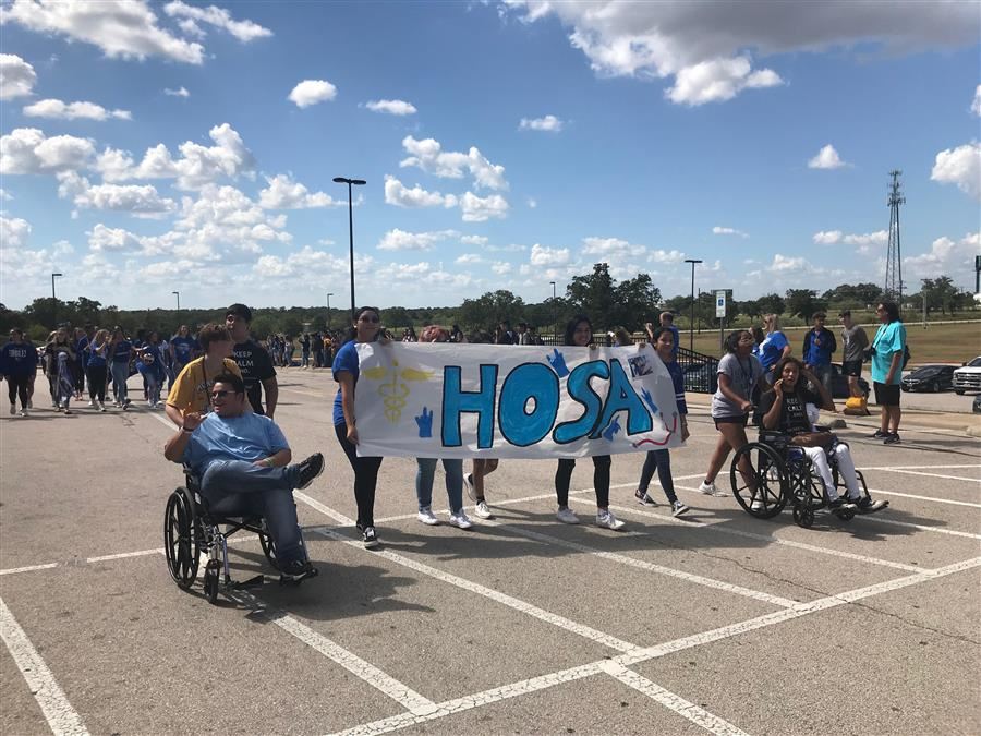 HOSA sign held by students